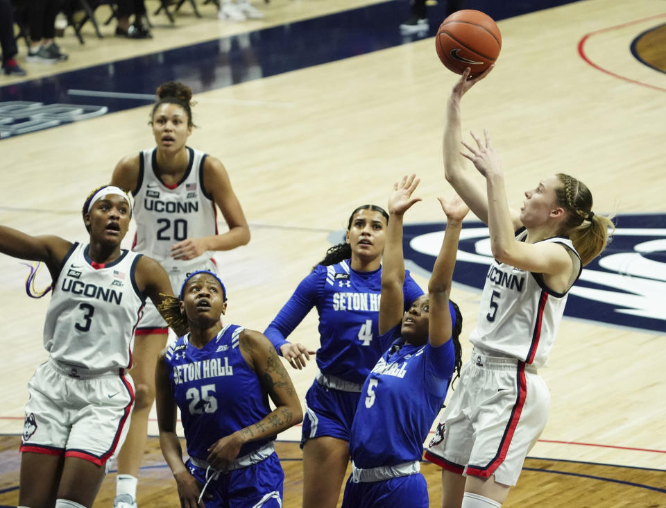 Connecticut guard Paige Bueckers, right, shoots against Seton Hall guard Mya Jackson (5) during the first half of an NCAA college basketball game Wednesday, Feb. 10, 2021, in Storrs, Conn. (David Butler II/Pool Photo via AP)