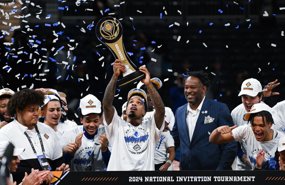 Apr 4, 2024; Indianapolis, IN, USA; Seton Hall Pirates guard Al-Amir Dawes (2) celebrates with the trophy after defeating the Indiana State Sycamores at Hinkle Fieldhouse. Mandatory Credit: Robert Goddin-USA TODAY Sports