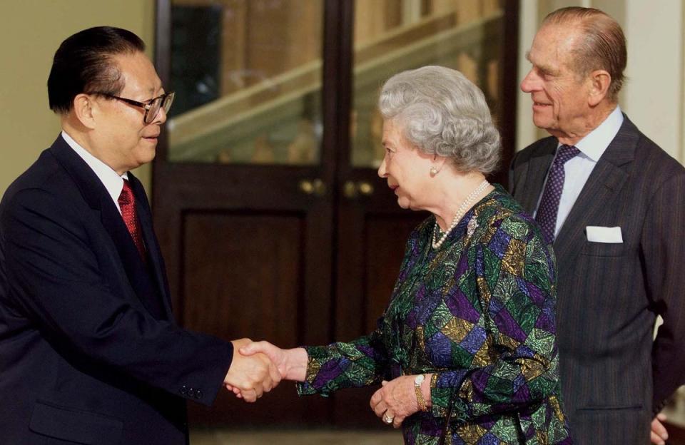 Jiang Zemin and the Queen Elizabeth II shake hands as Prince Philip looks on at the steps of Buckingham Palace 22 October 1999 (AFP via Getty Images)