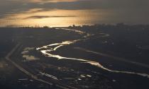 An aerial view from a helicopter shows the Adler district of the Black Sea resort city of Sochi, December 23, 2013. Sochi will host the 2014 Winter Olympic Games in February. Picture taken December 23, 2013. REUTERS/Maxim Shemetov (RUSSIA - Tags: CITYSCAPE SPORT OLYMPICS)