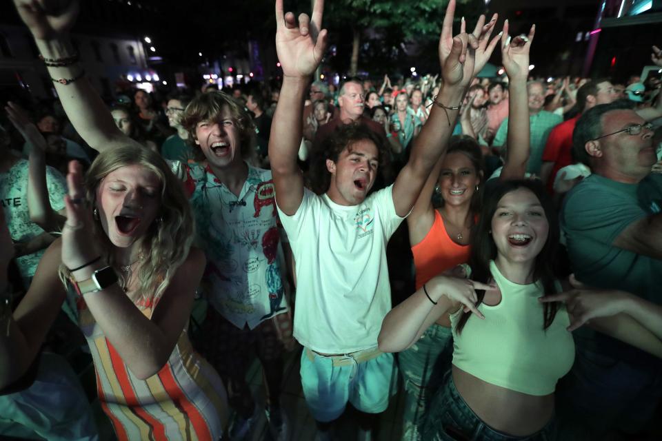 Attendees cheer for Chestnut Grove as they perform Aug. 4, 2022, at the Houdini Plaza Main Stage during the ninth annual Mile of Music.