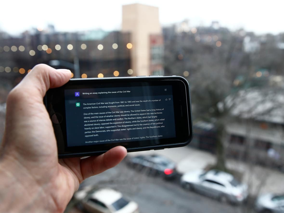 A ChatGPT prompt is shown on a device near a public school in Brooklyn, New York, Thursday, Jan. 5, 2023. New York City school officials have blocked the impressive but controversial writing tool that can generate paragraphs of human-like text. (Peter Morgan/The Associated Press - image credit)