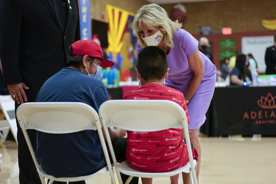 First lady Jill Biden speaks with people during a tour of a COVID-19 vaccination site at Isaac Middle School in Phoenix, Wednesday, June 30, 2021. (AP Photo/Carolyn Kaster, Pool)