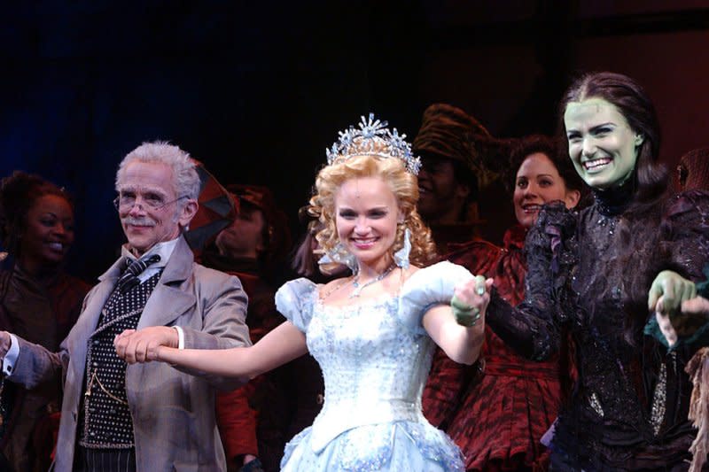 From left to right, Joel Grey, Kristin Chenoweth and Idina Menzel take their 2003 opening night curtain call bows at New York's Gershwin theatre after their performance in the Broadway musical "Wicked" by composer Stephen Schwartz. File Photo by Ezio Petersen/UPI