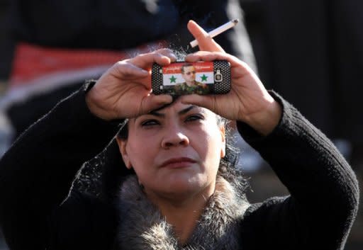 A Syrian government supporter takes pictures with her mobile phone bearing a sticker of Syrian President Bashar al-Assad during a pro-regime rally in Damascus in January 2012. For people living in countries where the the government monitors and censors the Internet, help is on the way