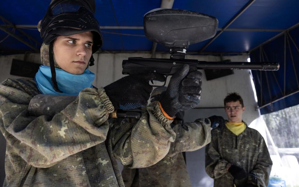 Ukrainian teens rest between games at Planeta paintball on July 9, 2023 in Kyiv, Ukraine. In Ukraine, paintball has become a popular way for kids to practice a war game during war time, as well as military who need to relax after fighting on the front lines.