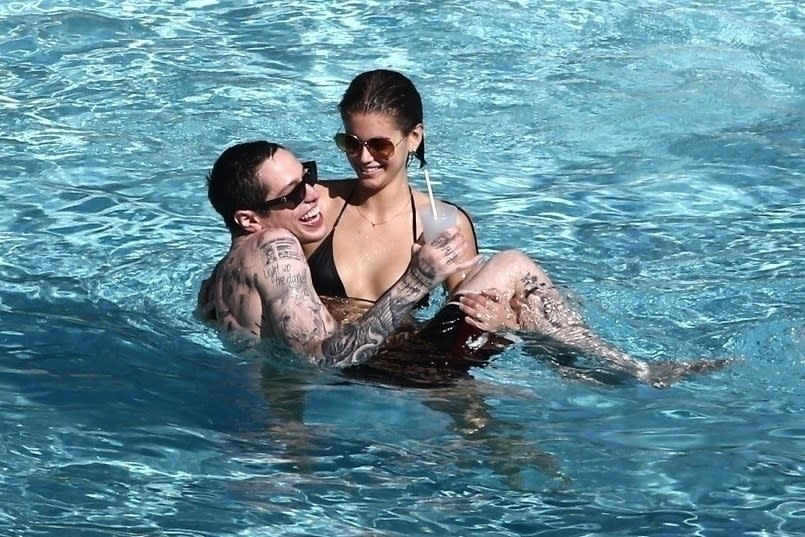 Kaia holding Pete in the pool