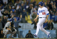 <p>Los Angeles Dodgers’ Ross Stripling, right, scores the winning run on a walk off double by Austin Barnes as Pittsburgh Pirates relief pitcher Daniel Hudson crouches at home during the 10th inning of a baseball game, May 9, 2017, in Los Angeles. (Photo: Mark J. Terrill/AP) </p>