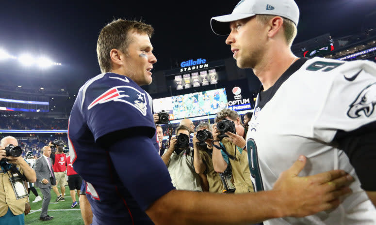 Tom Brady and Nick Foles shake hands.