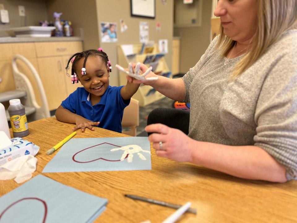 Deshay Dothard, 3, makes artwork celebrating Black History month with the help of her teacher, Brittany Crotz, at Carver Center Feb. 21, 2024.