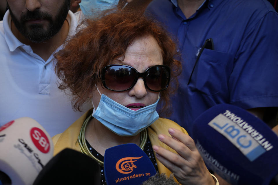 Lebanese Judge Ghada Aoun speaks to journalists at the entrance of the Central Bank after a raid in pursuit of Central Bank Governor Riad Salameh, who she has charged for corruption in Beirut, Lebanon, Tuesday, July 19, 2022. (AP Photo/Bilal Hussein)
