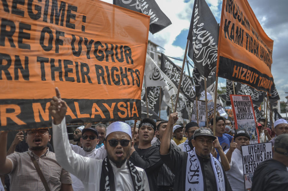 Protesters march while holding placards during a protest held in solidarity with the Uighur community in China, in Kuala Lumpur December 27, 2019. — Picture by Shafwan Zaidon