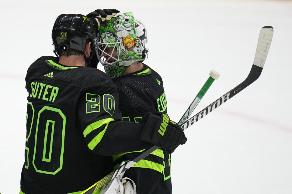 Dallas Stars goaltender Scott Wedgewood, right, reacts with defenseman Ryan Suter (20) after an NHL hockey game against the Minnesota Wild, Wednesday, Jan. 10, 2024, in Dallas. The Stars won 7-2. (AP Photo/Julio Cortez)