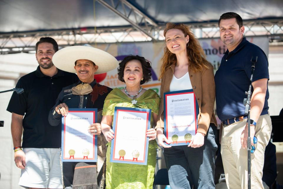 Jackson Mayor Scott Conger, Eduardo Morales and Dr. Sandra Dee, who are organizers and co-creators of the event, Lizzie Emmons, executive director of the Jackson Arts Council, and Madison County Mayor A.J. Massey pose for a picture after presenting proclamations declaring October National Arts and Humanities Month and Global Diversity Awareness Month in Jackson and Madison County during the International Food and Art Festival on Saturday, October 1, 2022, in Jackson, Tenn. 