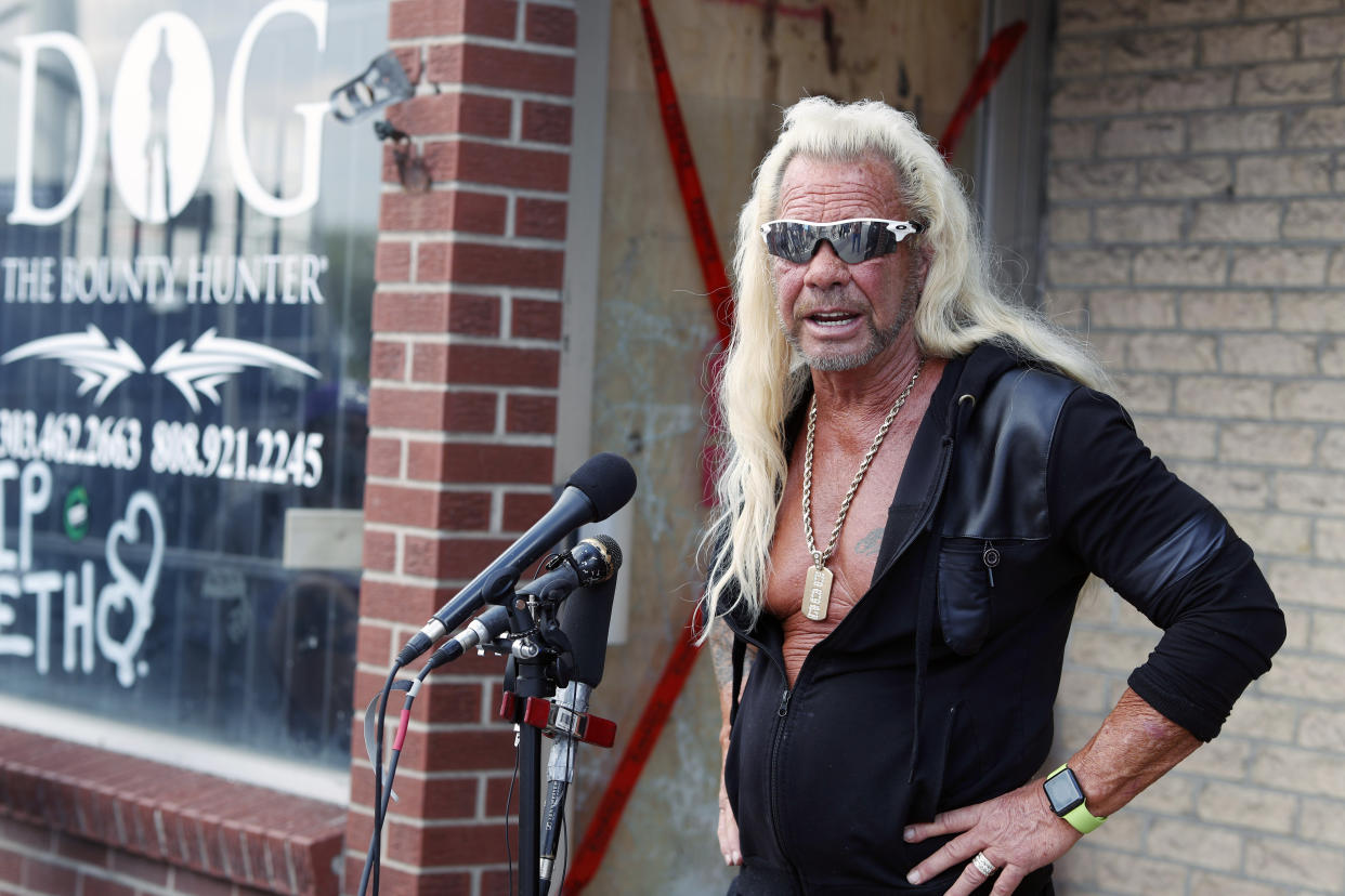 Duane "Dog the Bounty Hunter" Chapman talks to reporters outside his storefront that was burglarized Friday, Aug. 2, 2019, in Edgewater, Colo. Police in Colorado said Friday they are investigating a reported burglary of a business owned by "Dog the Bounty Hunter" reality TV star Duane "Dog" Chapman.(AP Photo/David Zalubowski)