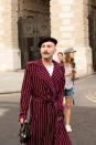 A guest is seen wearing a striped coat and beret. [Photo: PA]