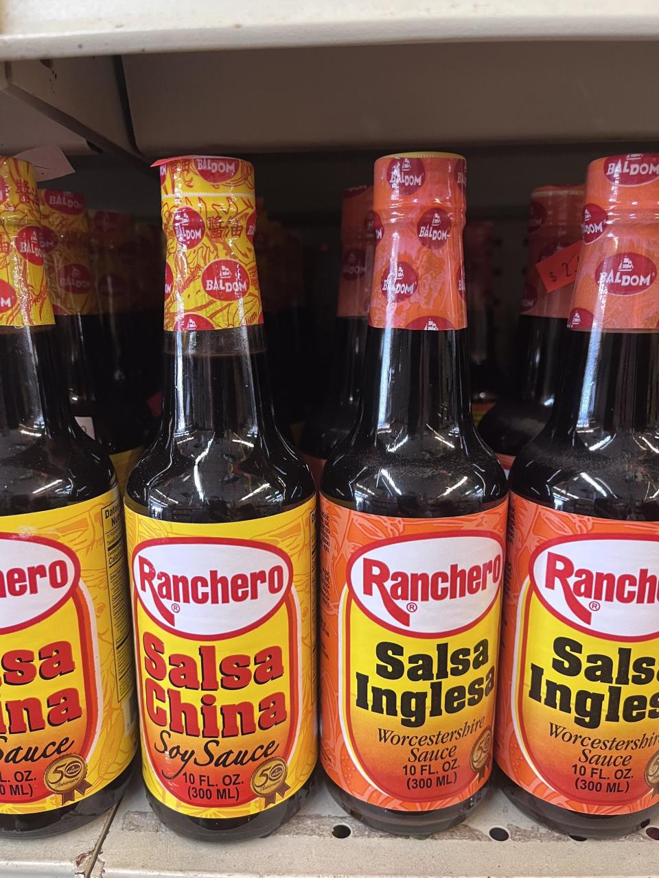 Bottles of salsa inglesa Worcestershire sauce and salsa China soy sauce on shelves