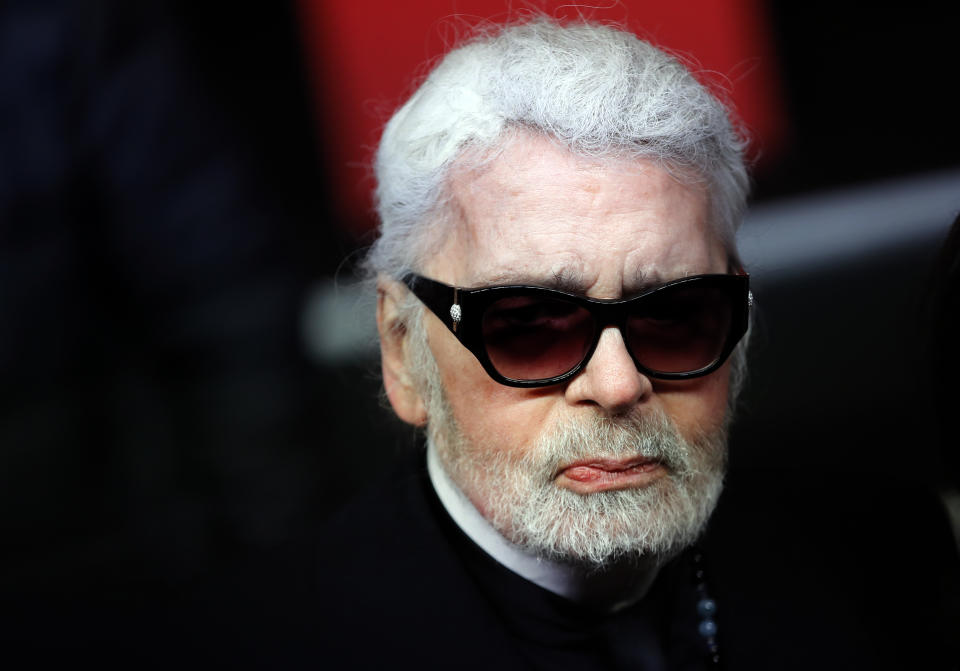 FILE - In this Thursday, Nov. 22, 2018 file photo, Fashion designer Karl Lagerfeld poses during the Champs Elysee Avenue illumination ceremony for the Christmas season, in Paris. Chanel's octogenarian designer Karl Lagerfeld, who has looked increasingly frail in recent seasons, did not come out to take a bow at the house's couture show in Paris, something the company attributed to him being tired, it was reported on Tuesday, Jan. 22, 2019. It is the first time in recent memory that Lagerfeld, who has designed for the house since 1983, has not come out to receive applause at the end of one of his shows. (AP Photo/Christophe Ena, File)