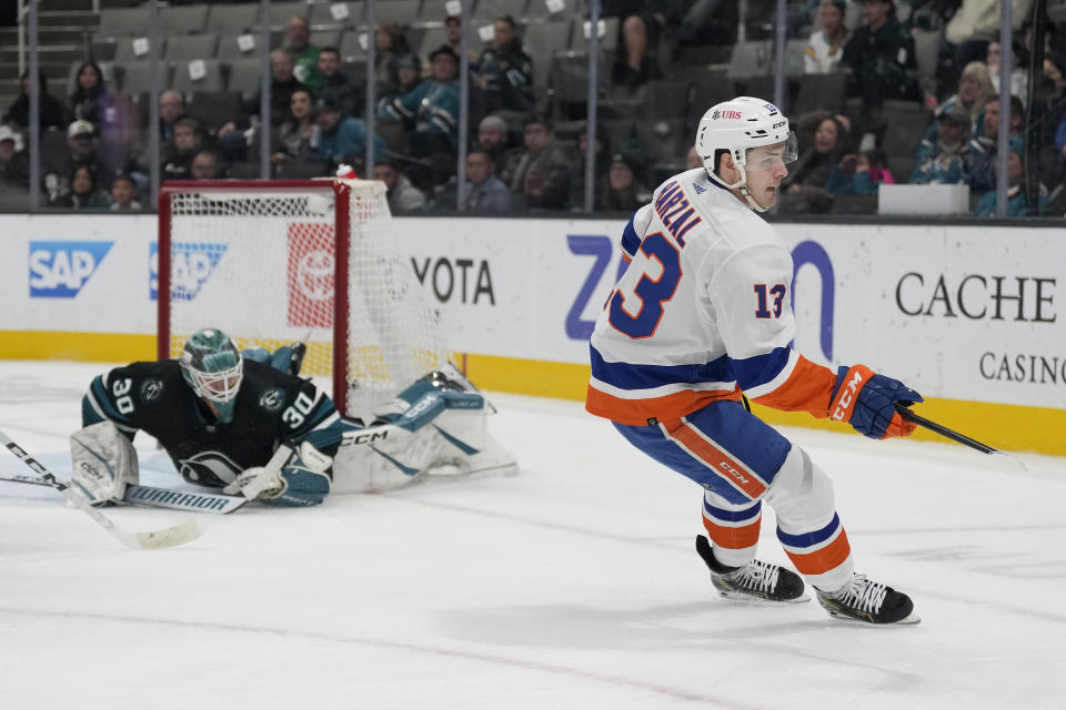 New York Islanders center Mathew Barzal, right, turns after scoring a goal past San Jose Sharks goaltender Magnus Chrona (30) during the second period of an NHL hockey game in San Jose, Calif., Thursday, March 7, 2024. (AP Photo/Jeff Chiu)