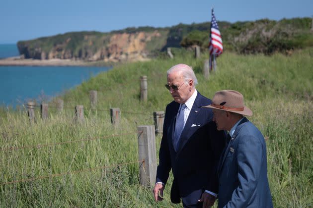 U.S. President Joe Biden, left, walks past the cliffs of the Normandy shore with Scott Desjardins, superintendent of the Normandy American Cemetery, before speaking at Pointe du Hoc amid the 80th anniversary of D-Day on June 7, 2024, in France.