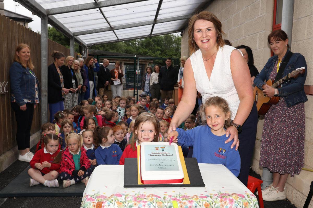 Enniskillen Nursery principal, Lisa Phair, gets help from some of the nursery children in cutting the cake celebrating 25 year of the nursery school. <i>(Image: Tim Flaherty)</i>