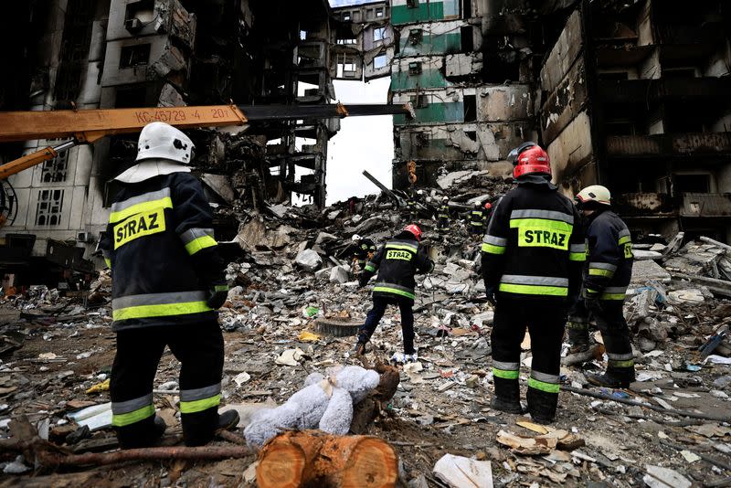 FILE PHOTO: Rescuers search for bodies under the rubble of a building destroyed by Russian shelling, amid Russia's invasion of Ukraine, in Borodyanka