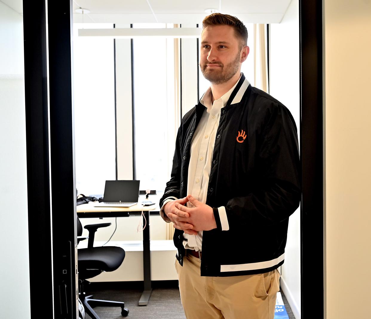 Tim Hally, co-founder of Munq, stands in his office doorway at Venture X on Front Street in Worcester.