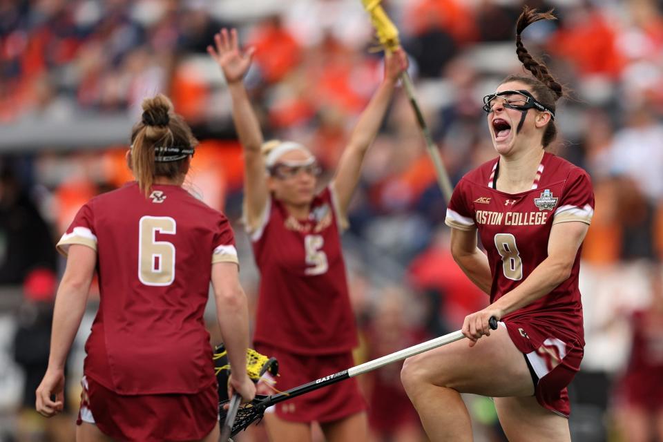 Charlotte North (right) celebrates after scoring a goal in the 2021 NCAA title game.
