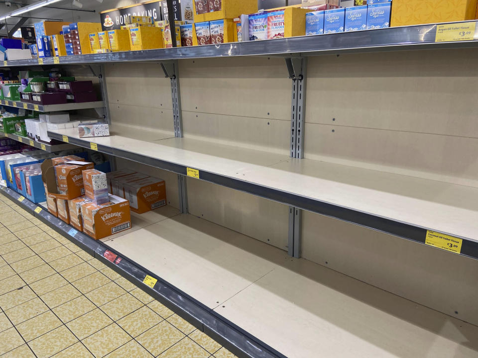 Shelves are stripped bare in Aldi Supermarket Stalybridge, Manchester in response to the Coronavirus. 