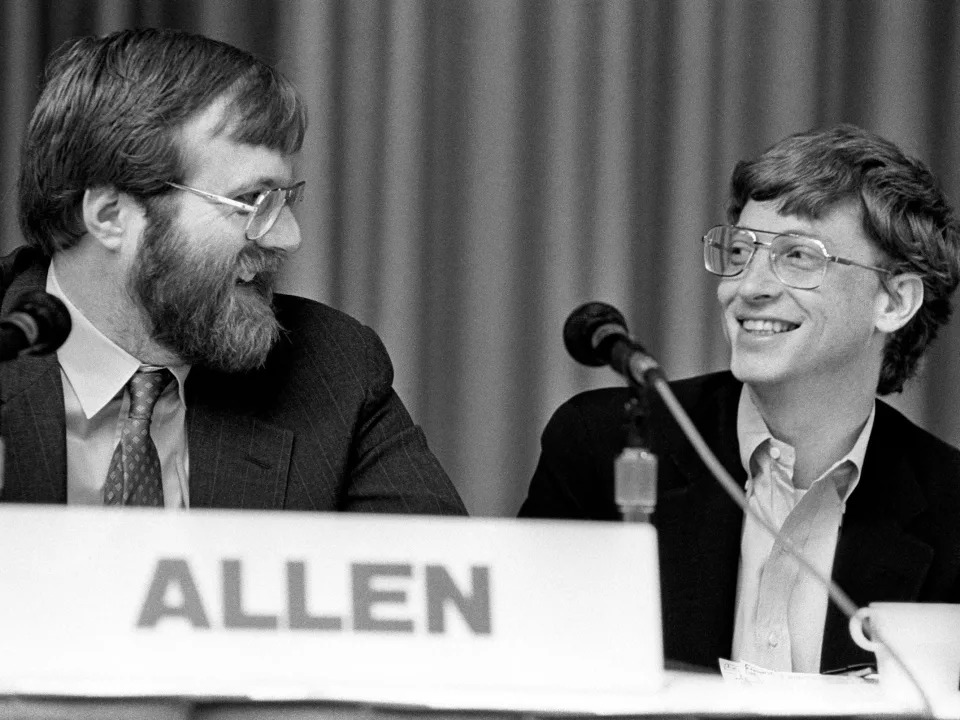 Microsoft founders Paul Allen and Bill Gates look at each other during panel in 1987