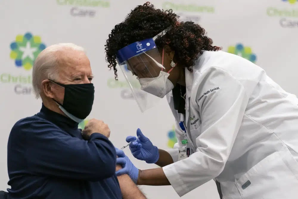 President-elect Joe Biden receives his first dose of the coronavirus vaccine from Nurse partitioner Tabe Mase at Christiana Hospital in Newark Del., on Dec. 21, 2020, from nurse practitioner. (AP Photo/Carolyn Kaster, File)