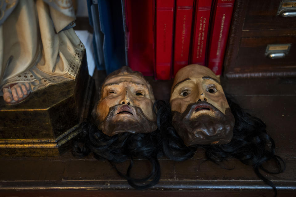 Masks depicting two of the Twelve Apostles lay on a table before being worn by members of the "Penitencia de los Apóstoles y Discípulos de Jesús" Catholic brotherhood during a Holy Week procession in the southern city of Alcala la Real, Spain, Thursday, March 28, 2024. (AP Photo/Bernat Armangue)