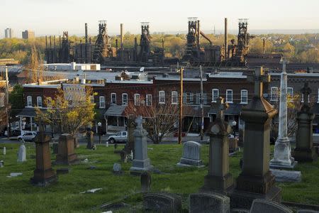 The blast furnaces of the now-closed Bethlehem Steel mill, sit behind row houses and a cemetery in Bethlehem, Pennsylvania, U.S. April 21, 2016. REUTERS/Brian Snyder