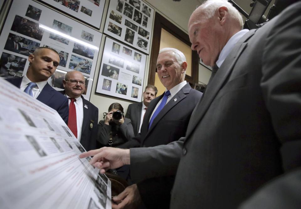 Republican Vice President Mike Pence, center, listens to Secretary of State Bill Gardner, right, as Pence files forPresident Donald Trump to be listed on the New Hampshire primary ballot, Thursday, Nov. 7, 2019, in Concord, N.H. (AP Photo/Charles Krupa)