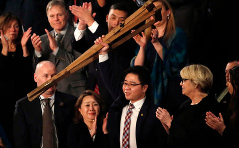 North Korean defector Ji Seong-ho is acknowledged by U.S. President Trump as he delivers his State of the Union address in Washington - Credit: Reuters