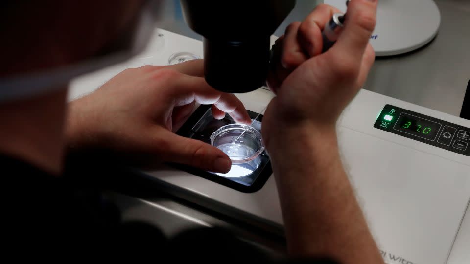 Lab staff prepare small Petri dishes, each holding several 1-7 day old embryos, for cells to be extracted from each embryo to test for viability at the Aspire Houston Fertility Institute IVF lab on Tuesday, February 27. - Michael Wyke/AP