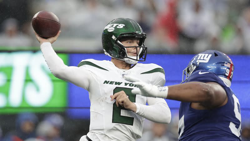 New York Jets quarterback Zach Wilson (2) passes against New York Giants defensive lineman Dexter Lawrence II (97) during the second half of an NFL football game, Sunday, Oct. 29, 2023, in East Rutherford, N.J. 
