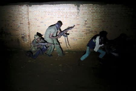 Armed vigilantes patrol in the center of Bujumbura, Burundi, November 20, 2015. Picture taken November 20, 2015. REUTERS/Goran Tomasevic