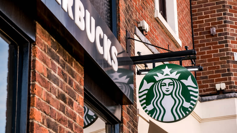 A Starbucks sign outside a store.