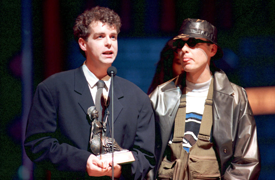 THEN: Chris Lowe, left, and Neil Tennant of the Pet Shop Boys accept their award at the British Industry Awards at the Royal Albert Hall in London, England, Monday evening, Feb. 8, 1988. (AP Photo/Gill Allen)