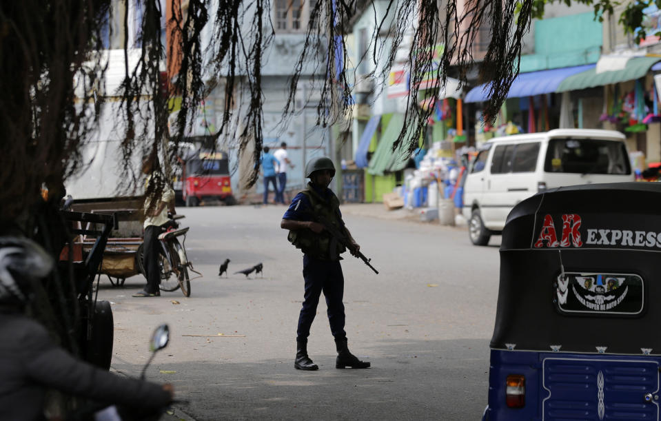 A Sri Lankan naval soldier stands guard at a road leading to a closed market on May Day in Colombo, Sri Lanka, Wednesday, May 1, 2019. Sri Lanka's major political parties called off traditional May Day rallies due to security concerns following the Easter bombings that killed more than 250 people and were claimed by militants linked to the Islamic State group. (AP Photo/Eranga Jayawardena)