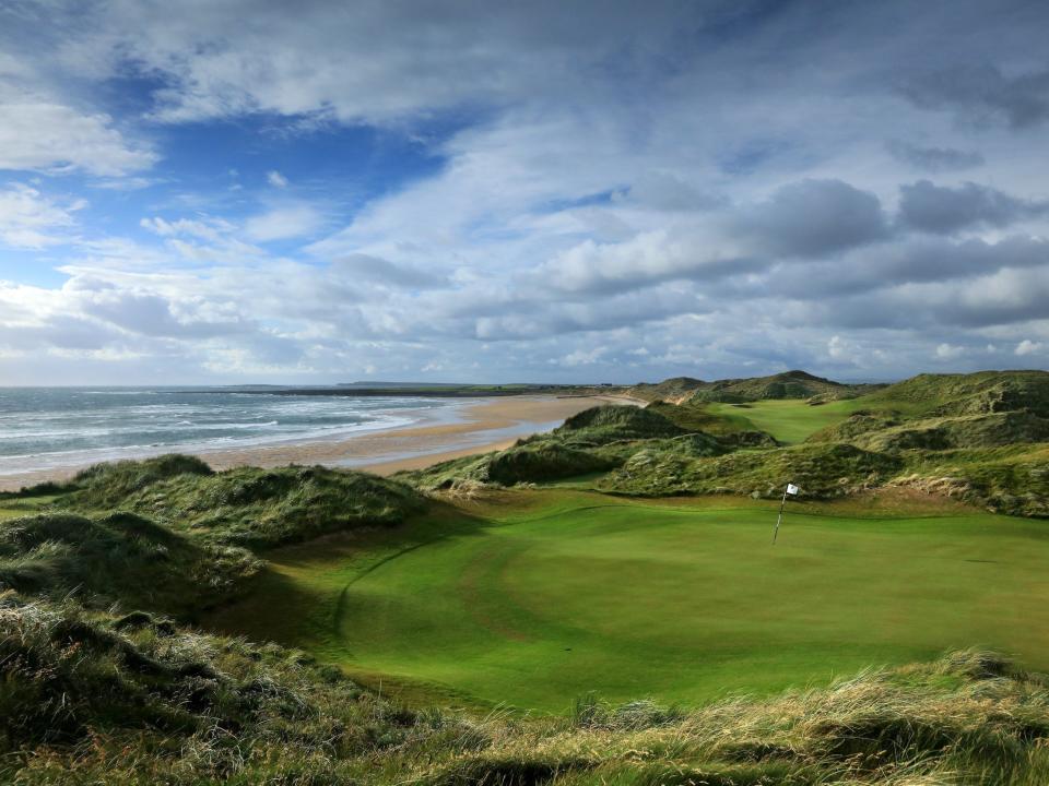 A golf course with the beach in the background