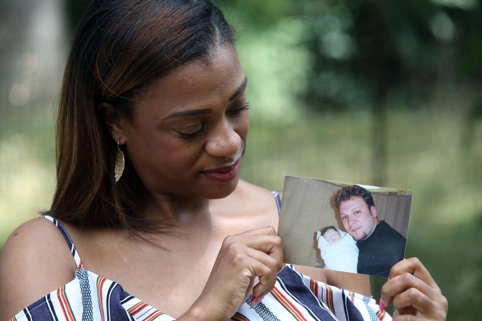 Marjorie Vail of Brooklyn holds a picture of her husband Roman Vail with their son Aleksei, who was born still in September of 2004, July 15, 2022 in Brooklyn. Marjorie Vail is a founding member of PUSH for Empowered Pregnancy, where she is also the co-director of awareness.