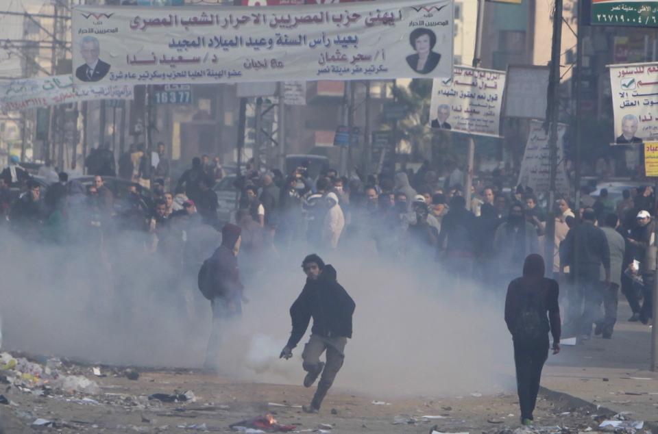 Supporters and opponents of ousted President Mursi clash at Nasr City district in Cairo