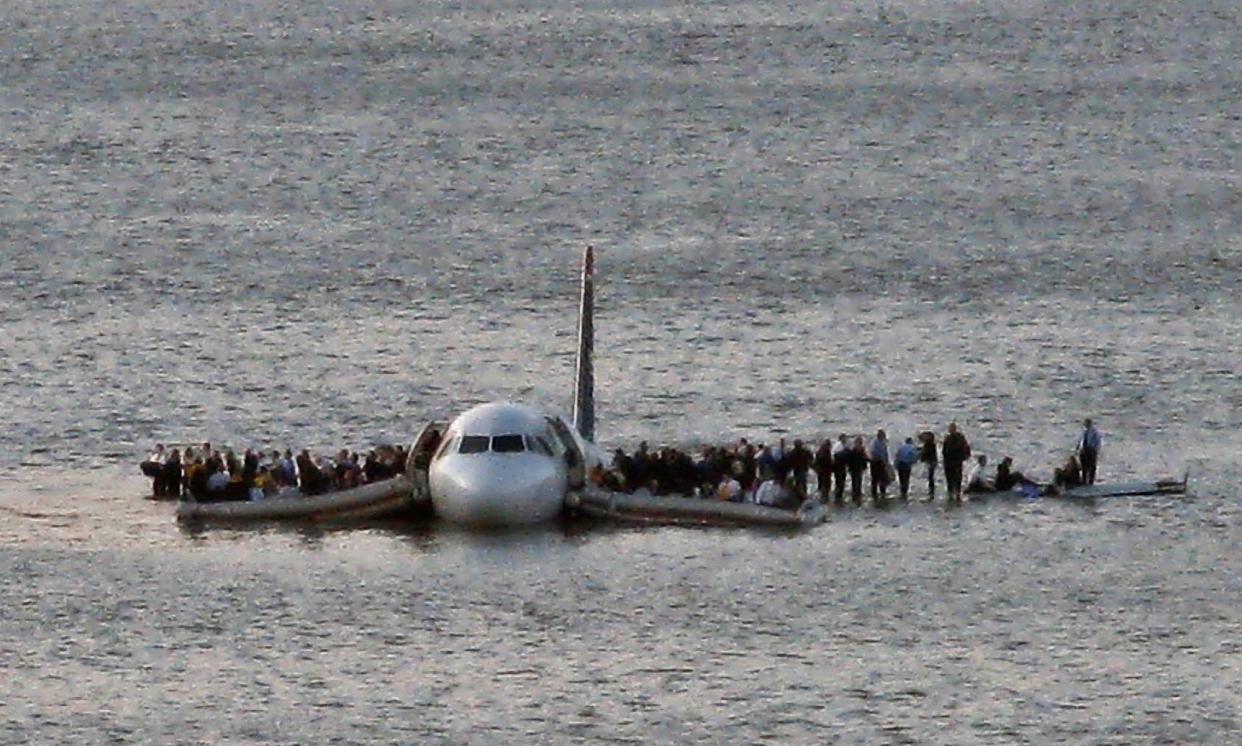 In this file photo from Jan. 15, 2009, airline passengers wait to be rescued on the wings of a US Airways Airbus 320 jetliner that safely emergency landed in the frigid waters of the Hudson River in New York after a flock of birds knocked out both its engines.