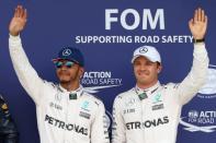 Britain Formula One - F1 - British Grand Prix 2016 - Silverstone, England - 9/7/16 Mercedes' Lewis Hamilton celebrates qualifying in pole position Mercedes' Nico Rosberg who finished in second place and Red Bull's Max Verstappen who finished in third Reuters / Matthew Childs Livepic