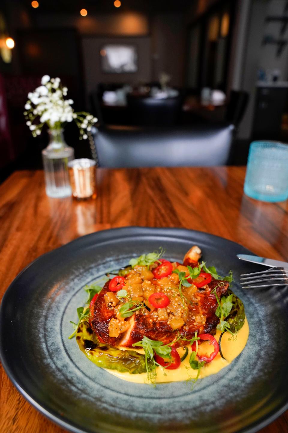 The heritage pork chop with corn pudding, burnt pineapple mostarda, shishitos and pickled fresno at Gioia Mia in Montclair.