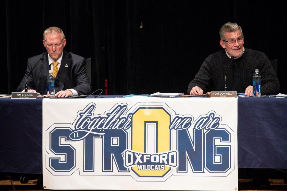Oxford Community Schools Board of Education President Tom Donnelly, right, speaks next to Superintendent Tim Throne, left, during a Board of Education meeting at Oxford Middle School in Oxford on Dec. 14, 2021.