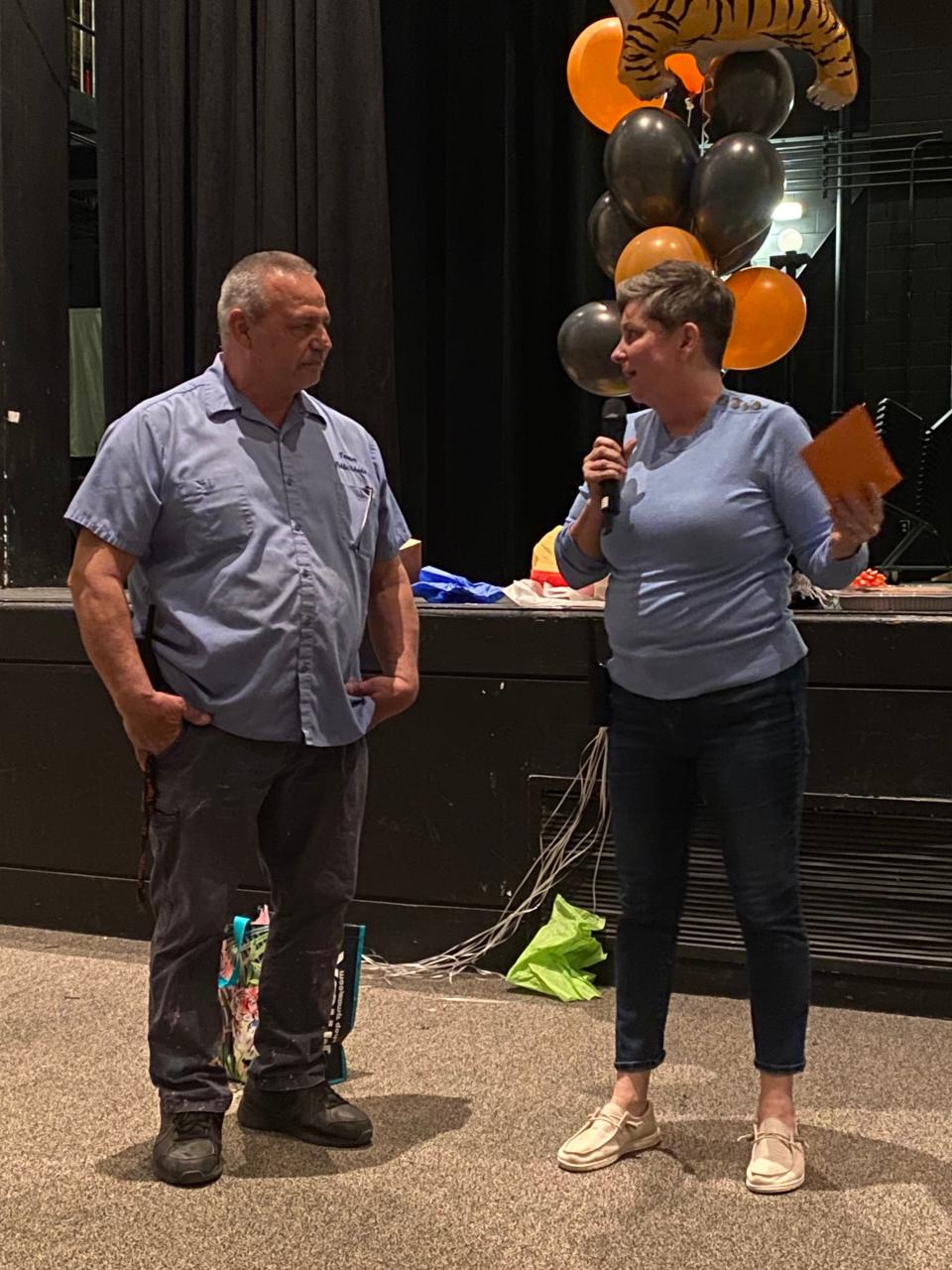 Head Custodian Steve Medeiros and Taunton High School Assistant Principal Kristen Keenan. On Wednesday, April 12, 2023, Taunton High School threw a giant retirement party for Medeiros in the auditorium after school.