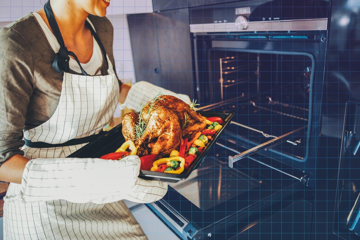 woman holding a pan with turkey and vegetables